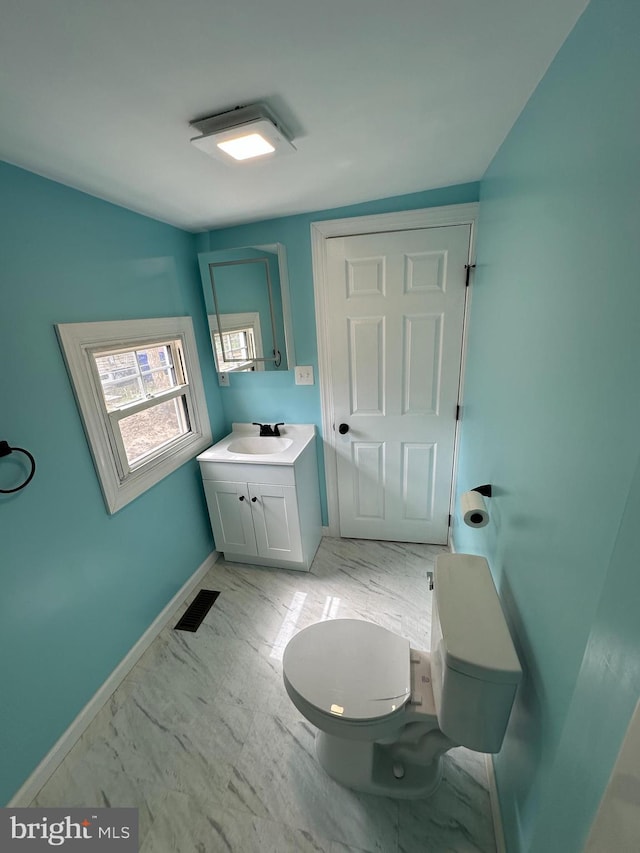 bathroom with marble finish floor, visible vents, toilet, vanity, and baseboards