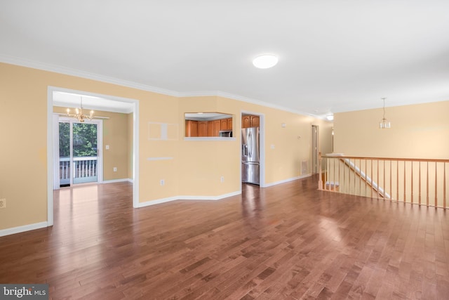3580 Diamond Point Mews, Dumfries, VA 22026 - unfurnished room with crown molding, wood finished floors, an inviting chandelier, baseboards, and visible vents