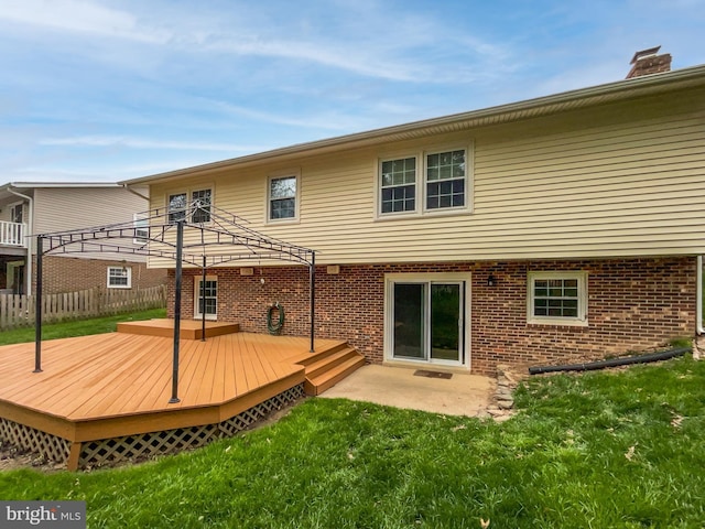 4987 Dequincey Dr, Fairfax, VA 22032 - back of house featuring a wooden deck, a yard, fence, brick siding, and a chimney