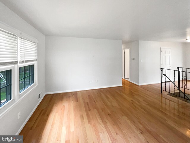 4987 Dequincey Dr, Fairfax, VA 22032 - unfurnished living room with light wood-style flooring, baseboards, and a healthy amount of sunlight