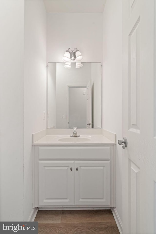 13945 Hollow Wind Way Unit 201, Woodbridge, VA 22191 - bathroom featuring vanity and wood finished floors