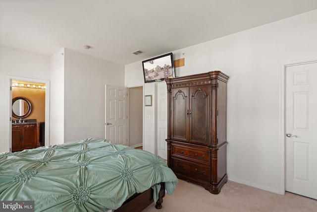 13945 Hollow Wind Way Unit 201, Woodbridge, VA 22191 - bedroom with ensuite bath, baseboards, visible vents, and light colored carpet