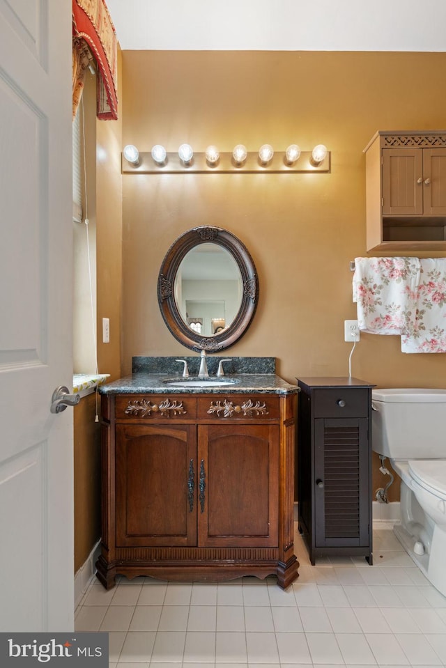 13945 Hollow Wind Way Unit 201, Woodbridge, VA 22191 - half bathroom featuring vanity, tile patterned flooring, and toilet