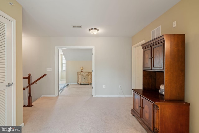13945 Hollow Wind Way Unit 201, Woodbridge, VA 22191 - hall featuring baseboards, visible vents, light colored carpet, and an upstairs landing
