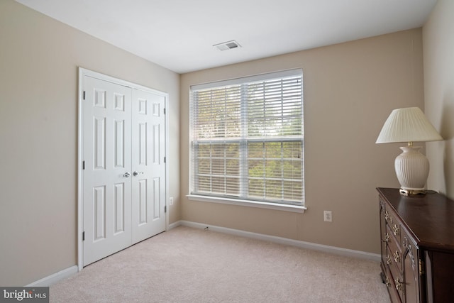 13945 Hollow Wind Way Unit 201, Woodbridge, VA 22191 - bedroom featuring visible vents, baseboards, carpet floors, and a closet