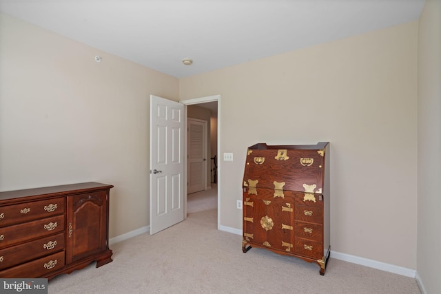 13945 Hollow Wind Way Unit 201, Woodbridge, VA 22191 - bedroom with baseboards and light colored carpet
