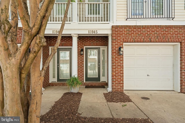 13945 Hollow Wind Way Unit 201, Woodbridge, VA 22191 - property entrance featuring brick siding, concrete driveway, and a garage