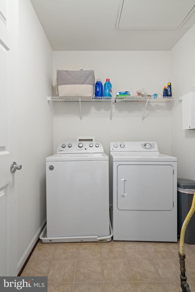 13945 Hollow Wind Way Unit 201, Woodbridge, VA 22191 - clothes washing area with washer and clothes dryer, laundry area, and light tile patterned flooring