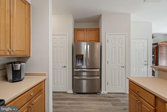 13945 Hollow Wind Way Unit 201, Woodbridge, VA 22191 - kitchen with light countertops, light wood-style floors, and stainless steel refrigerator with ice dispenser