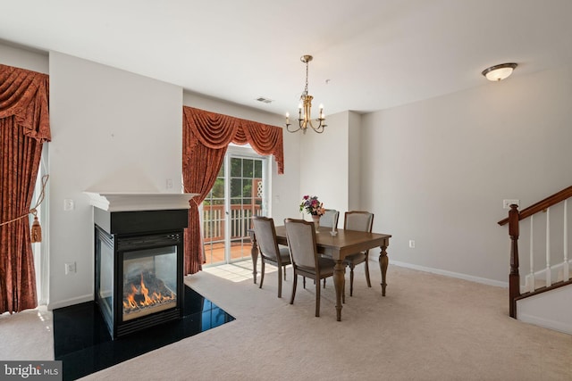 13945 Hollow Wind Way Unit 201, Woodbridge, VA 22191 - carpeted dining room with stairway, visible vents, a multi sided fireplace, baseboards, and a chandelier