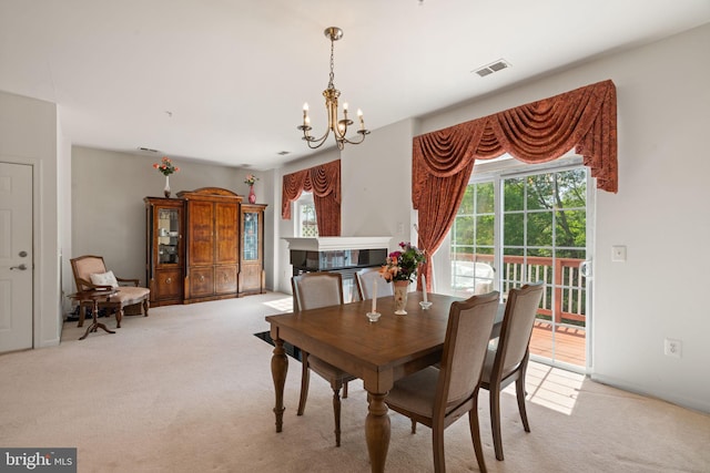 13945 Hollow Wind Way Unit 201, Woodbridge, VA 22191 - dining space with light colored carpet, an inviting chandelier, visible vents, and plenty of natural light