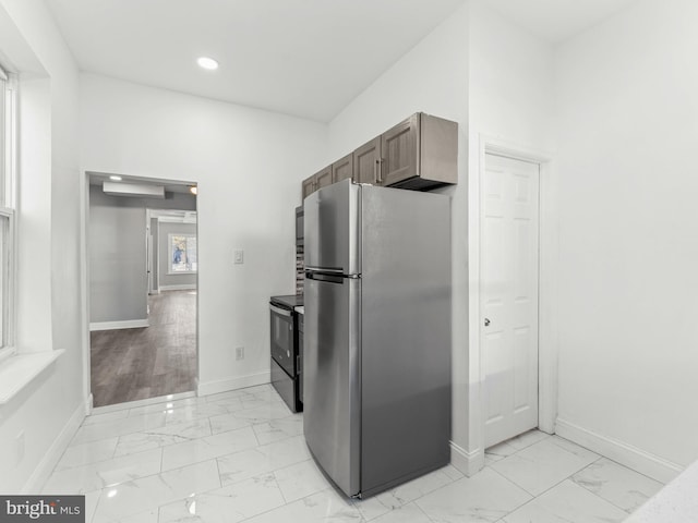 4841 N 13th St, Philadelphia, PA 19141 - kitchen with black range with electric cooktop, marble finish floor, freestanding refrigerator, baseboards, and recessed lighting