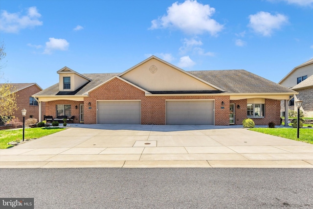 view of front of property featuring a shingled roof, a garage, driveway, and brick siding