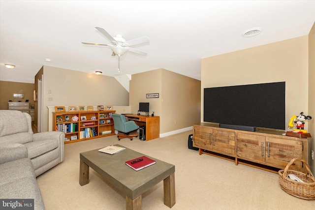 living area featuring carpet flooring, baseboards, a ceiling fan, and visible vents