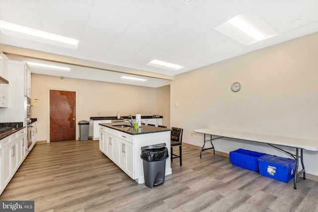 kitchen featuring white cabinetry and light wood-type flooring