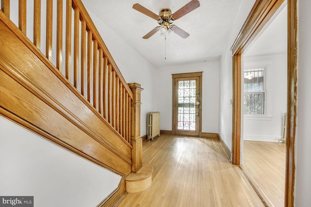4516 13th St NW, Washington, DC 20011 - foyer with light wood finished floors, stairs, healthy amount of natural light, and radiator