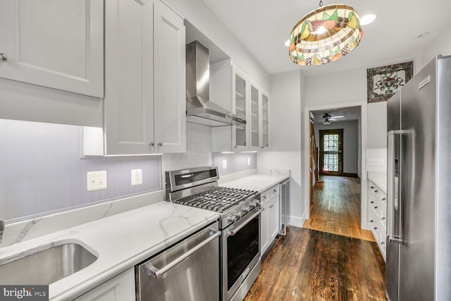 4516 13th St NW, Washington, DC 20011 - kitchen featuring appliances with stainless steel finishes, wall chimney exhaust hood, dark wood finished floors, and white cabinets