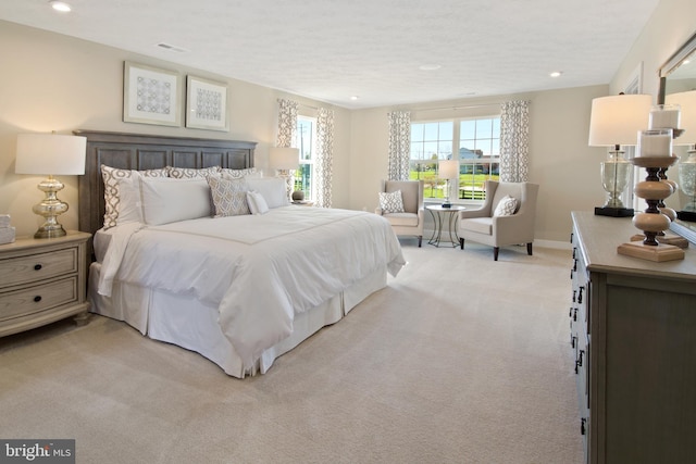 bedroom with baseboards, visible vents, recessed lighting, and light colored carpet