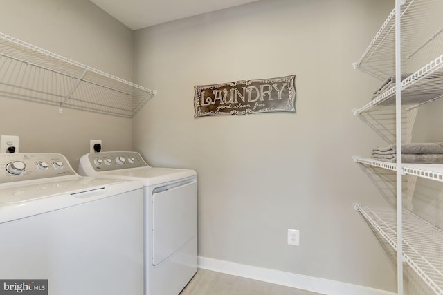 laundry area featuring laundry area, washer and clothes dryer, and baseboards