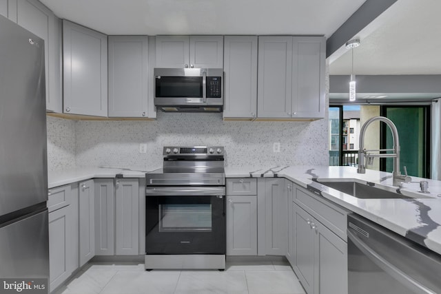 623 Center St Unit 101, Herndon, VA 20170 - kitchen featuring appliances with stainless steel finishes, gray cabinets, decorative backsplash, and light tile patterned flooring