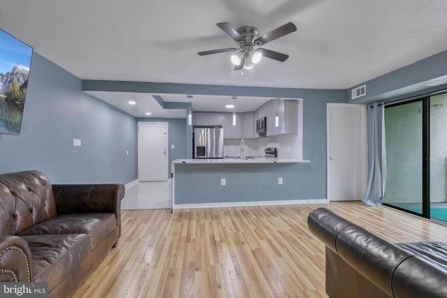 623 Center St Unit 101, Herndon, VA 20170 - living room with light wood-style floors and ceiling fan