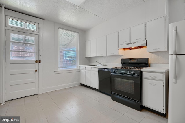kitchen with under cabinet range hood, light countertops, black appliances, and white cabinetry