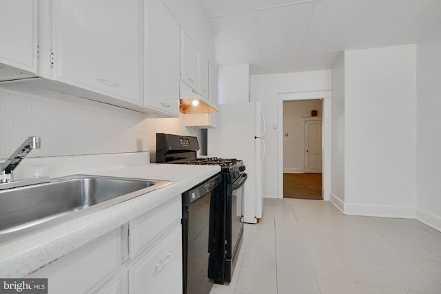 kitchen featuring light countertops, a sink, white cabinetry, and black appliances