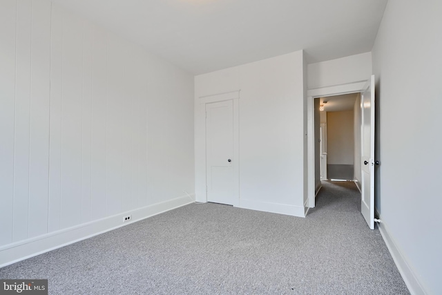 unfurnished bedroom featuring baseboards and carpet flooring