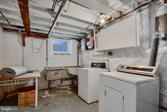 clothes washing area with separate washer and dryer and laundry area