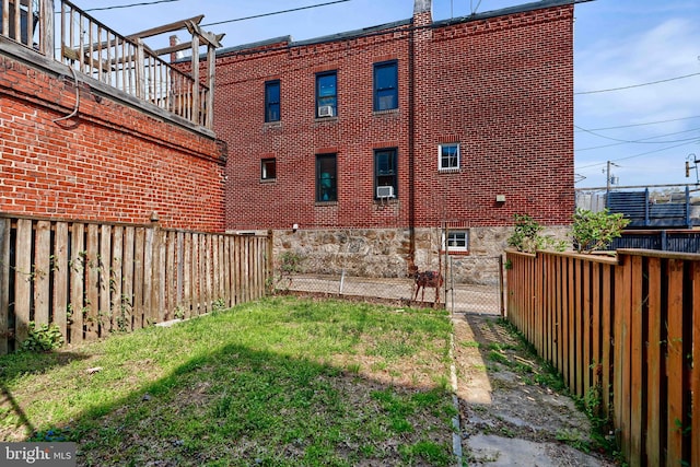 view of yard featuring fence and a gate