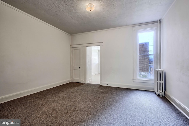 unfurnished room featuring ornamental molding, dark carpet, radiator, and a healthy amount of sunlight