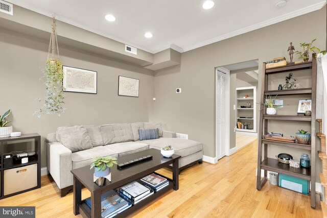 1936 Capitol Ave NE, Washington, DC 20002 - living room featuring crown molding, light wood-style floors, recessed lighting, and baseboards