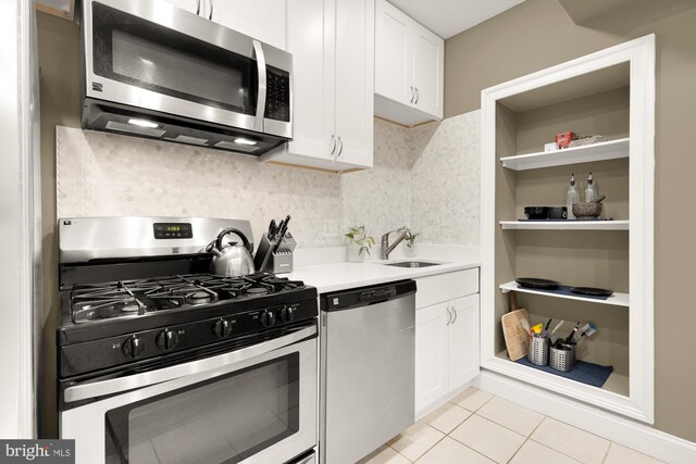1936 Capitol Ave NE, Washington, DC 20002 - kitchen featuring stainless steel appliances, a sink, white cabinets, and light countertops