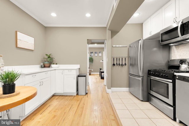 1936 Capitol Ave NE, Washington, DC 20002 - kitchen with stainless steel appliances, white cabinets, light wood-type flooring, light countertops, and recessed lighting