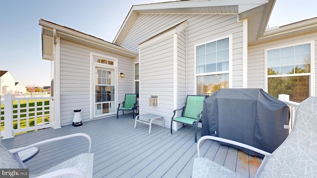 wooden deck featuring a grill