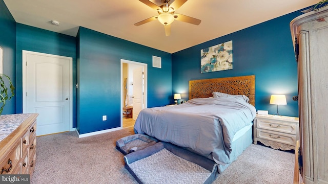 bedroom with a ceiling fan, ensuite bathroom, carpet, baseboards, and visible vents