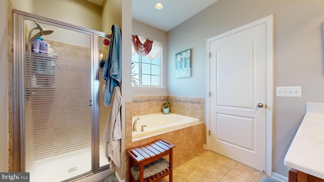 bathroom featuring a shower stall, a bath, vanity, and tile patterned flooring