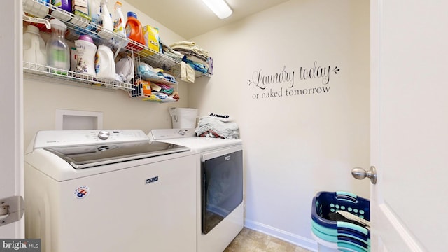clothes washing area featuring baseboards, washer and dryer, and laundry area