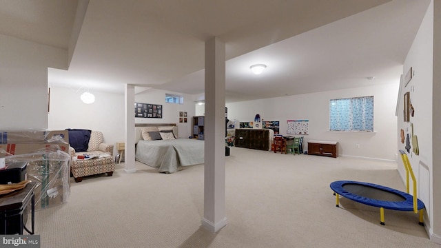 carpeted bedroom featuring baseboards