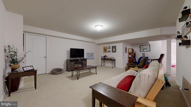 living room with light carpet and baseboards
