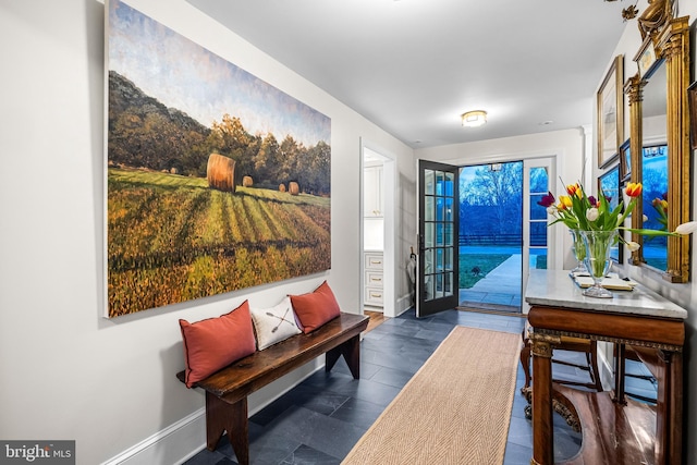 doorway to outside with baseboards