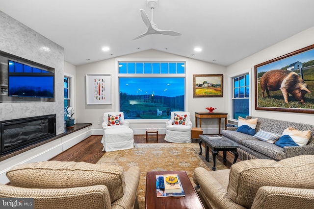 living area featuring vaulted ceiling, recessed lighting, a ceiling fan, wood finished floors, and a premium fireplace