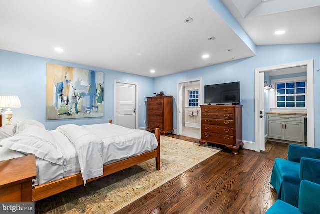 bedroom with dark wood-style flooring, connected bathroom, baseboards, and recessed lighting