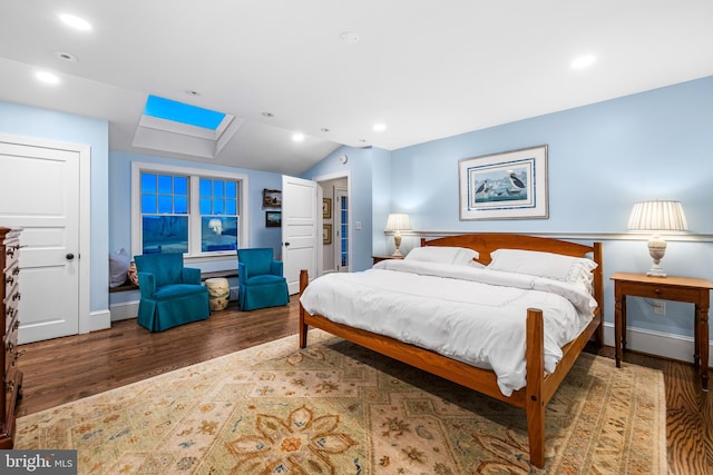 bedroom with recessed lighting, lofted ceiling, baseboards, and wood finished floors