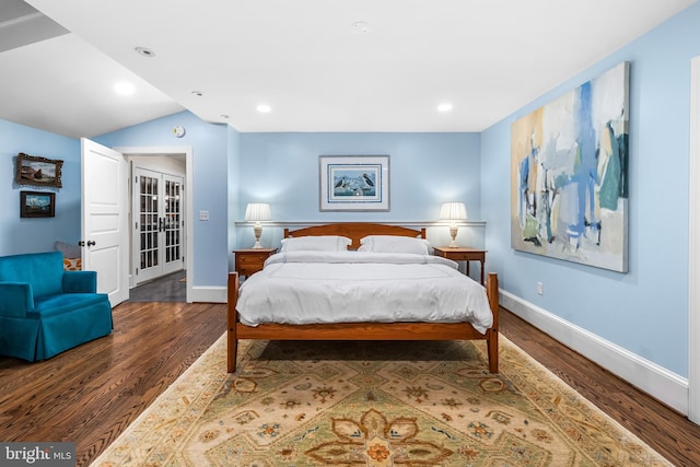 bedroom featuring recessed lighting, baseboards, vaulted ceiling, and wood finished floors