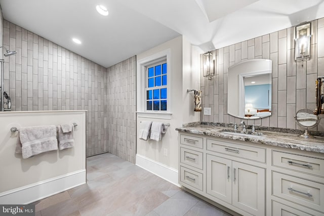 full bath featuring vanity, recessed lighting, walk in shower, tile patterned floors, and baseboards