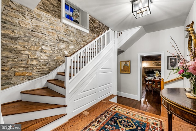 stairs featuring baseboards and hardwood / wood-style flooring