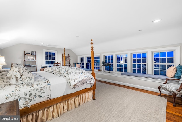 bedroom with recessed lighting, wood finished floors, and lofted ceiling