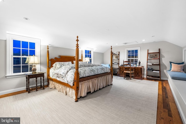 bedroom with baseboards, recessed lighting, vaulted ceiling, and wood finished floors