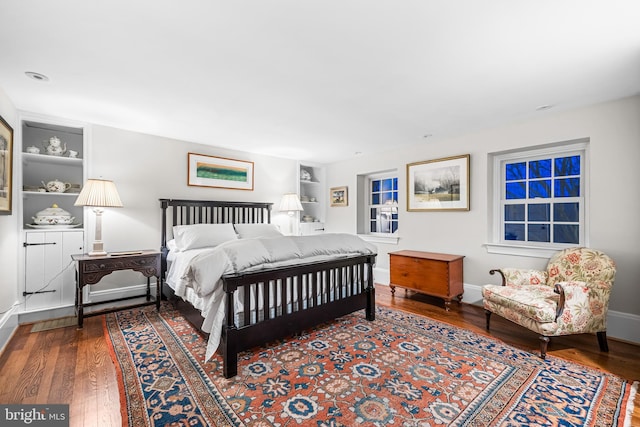 bedroom with baseboards and wood finished floors